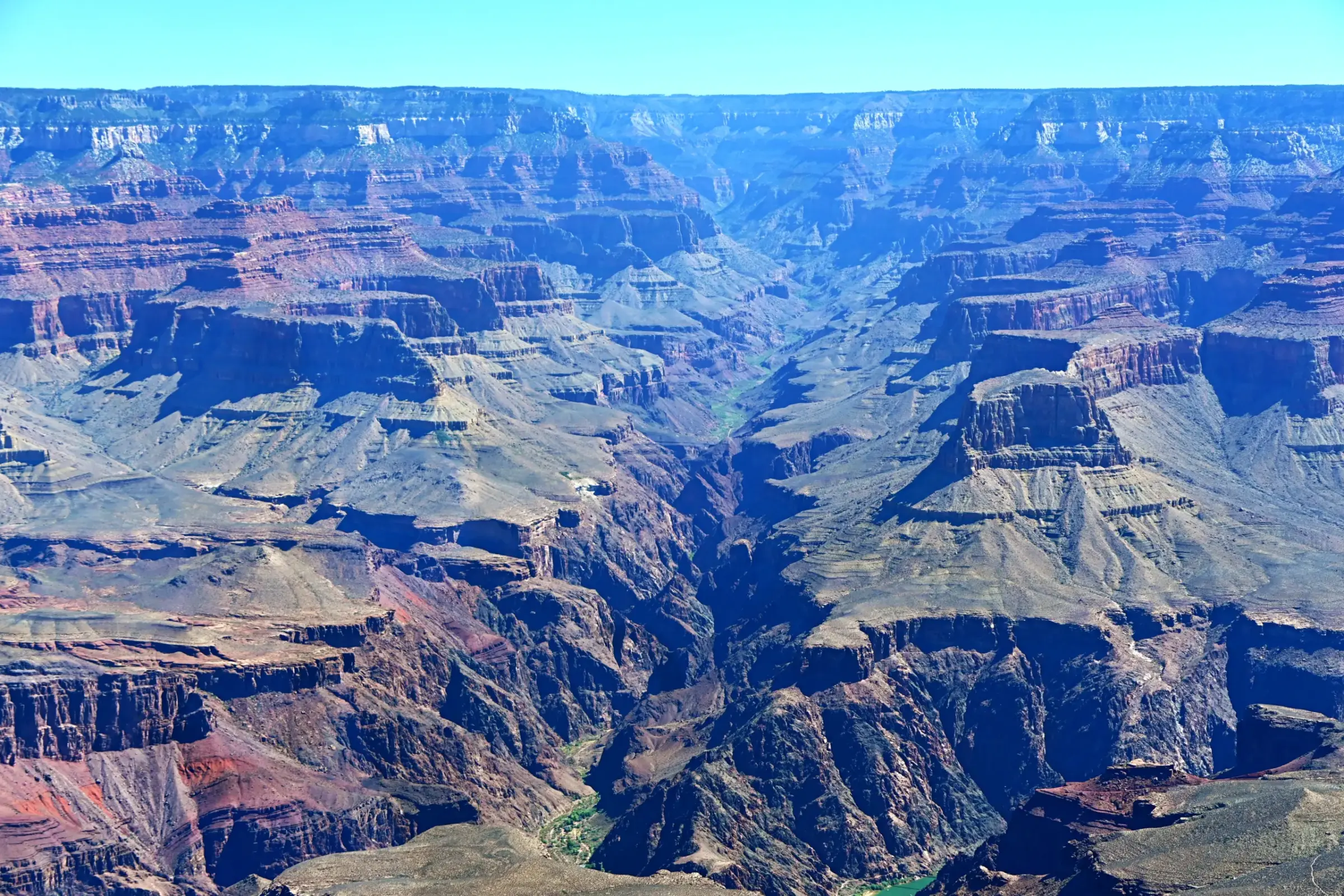 A deep view into the Grand Canyon, with the Colorado River winding far below.