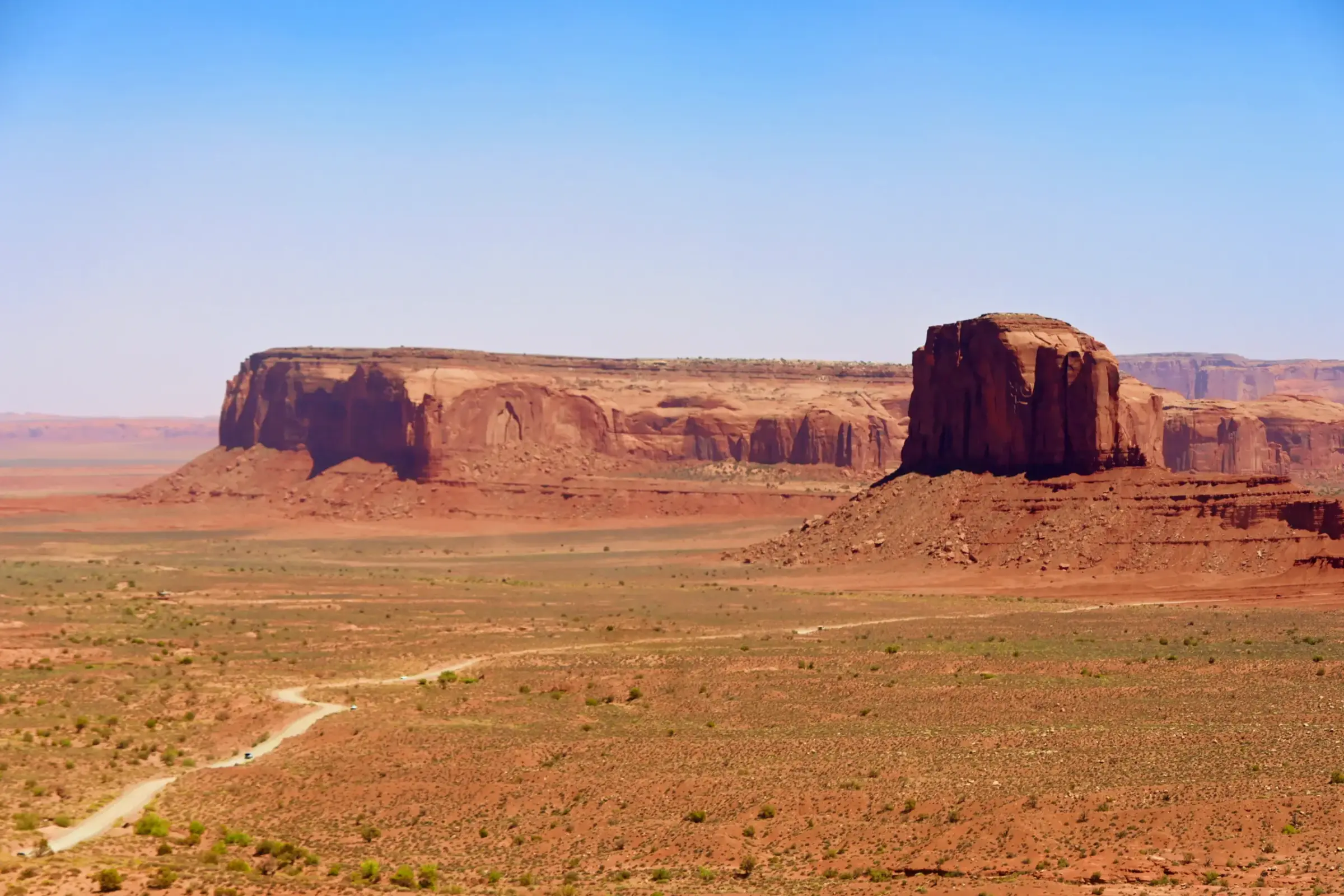 Red sandstone mesas and buttes across the open landscape of Monument Valley