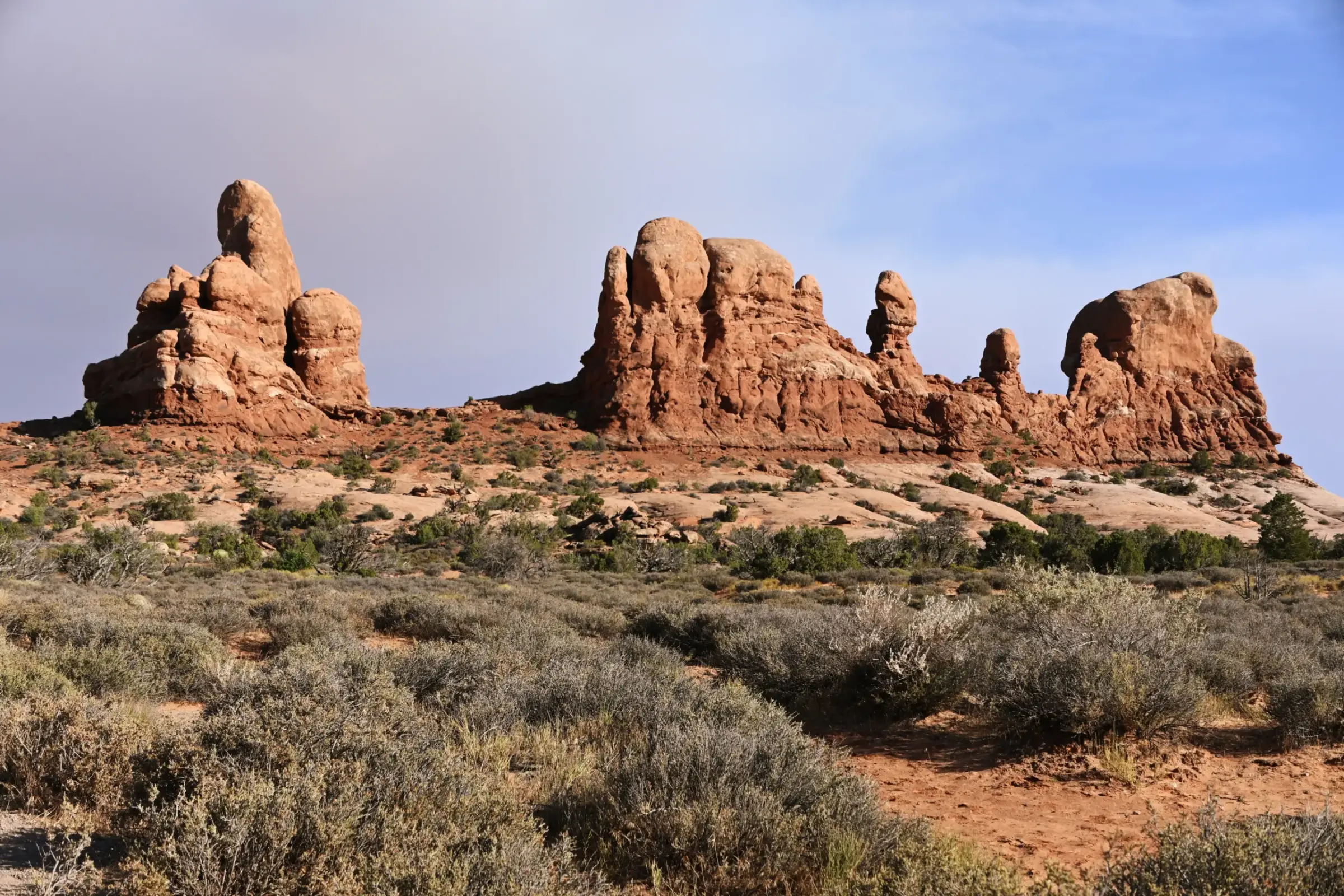 Weathered sandstone towers shaped by wind and time in Arches National Park