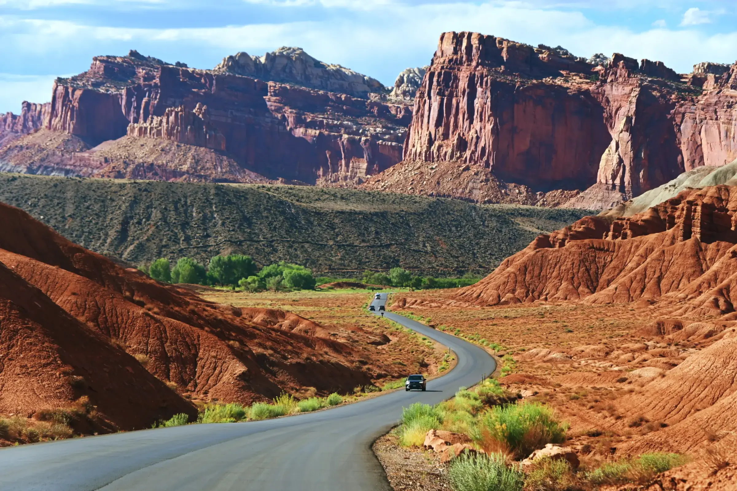 A winding road cutting through the colorful cliffs of Capitol Reef National Park